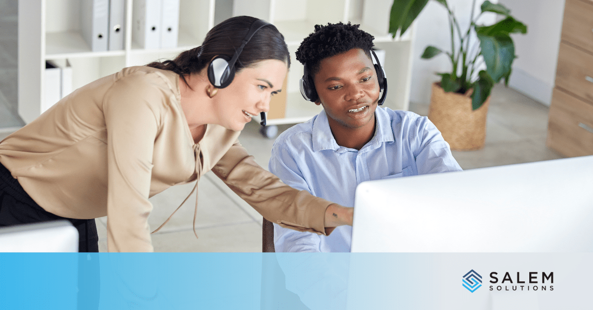 Two individuals at a computer, strategizing to optimize performance in an omnichannel contact center for customer service.