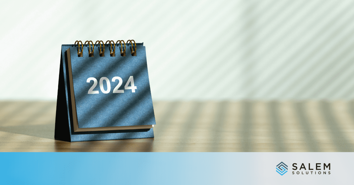 A desk calendar sitting on top of a wooden table.