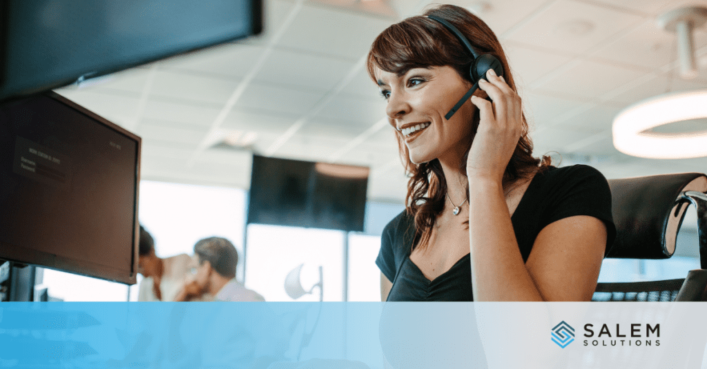 A woman talking on a headset in an office.