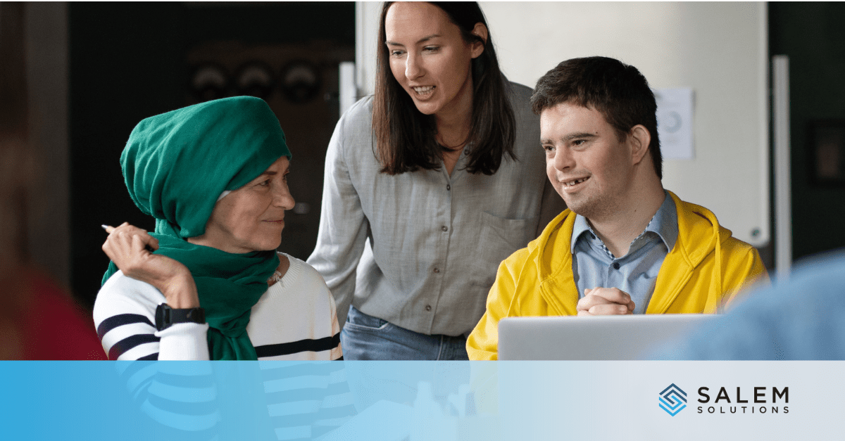 A group of people looking at a laptop.