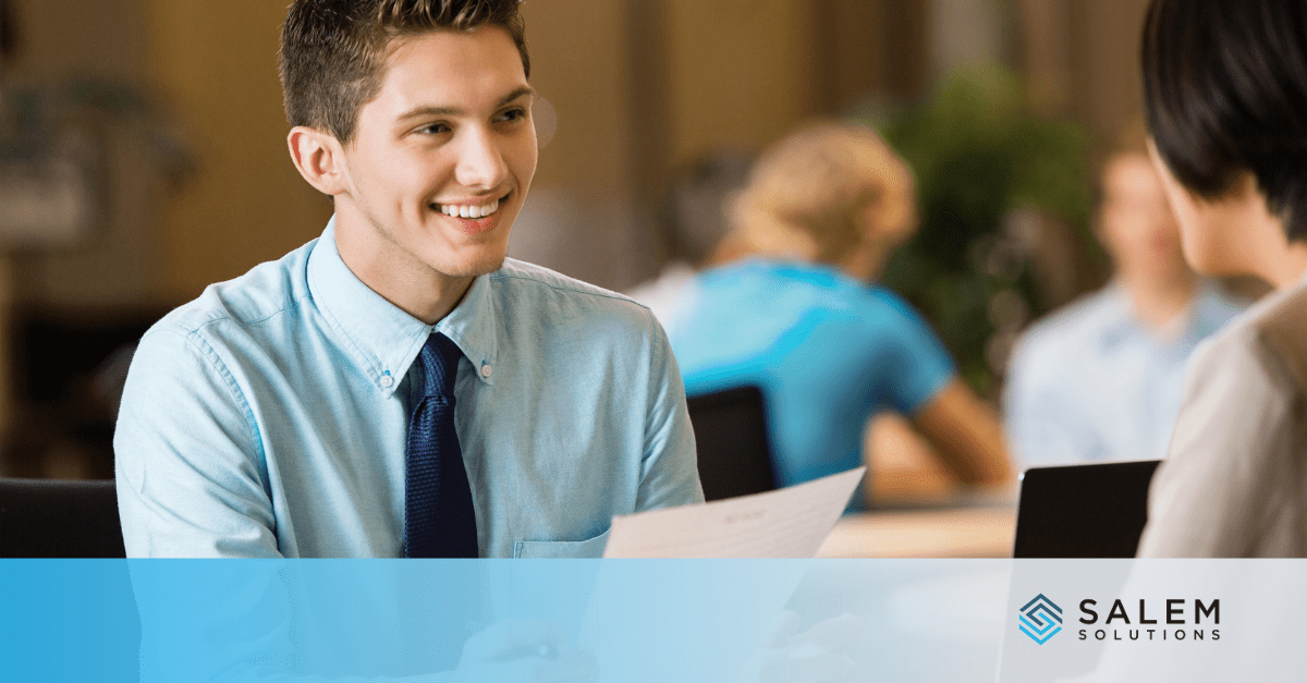 A man talks to a woman at a desk, focusing on entry-level administrative roles and customer service jobs for new graduates.