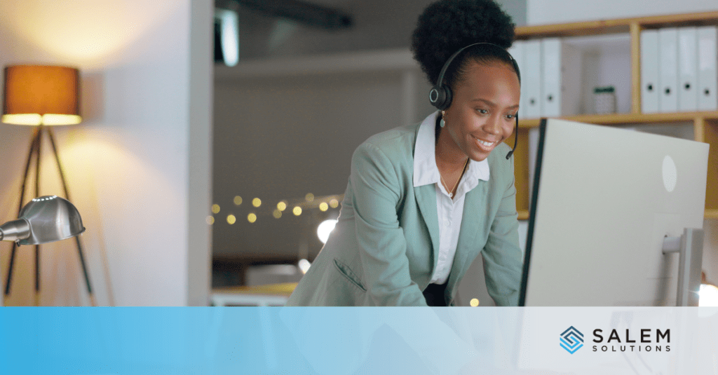 A woman in a suit focused on her computer, highlighting the importance of empathy and emotional intelligence in customer service.