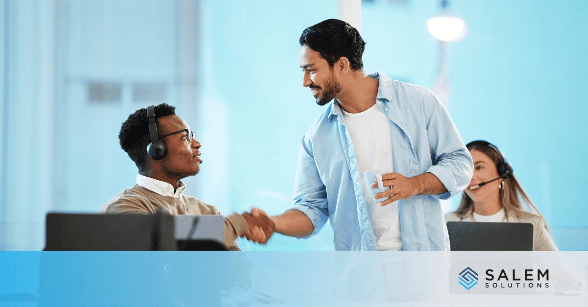 Two men shaking hands in front of a computer, symbolizing networking for career advancement strategies.