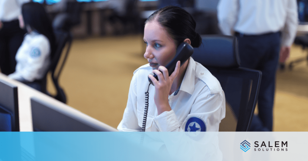 A government call center agent assisting a caller by phone while reviewing case details on a computer during peak season.