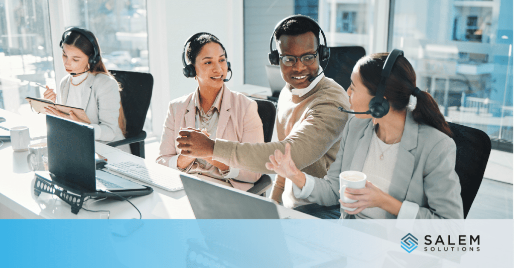 Healthcare call center agent working alone while other team members interact, illustrating early signs of burnout and isolation.