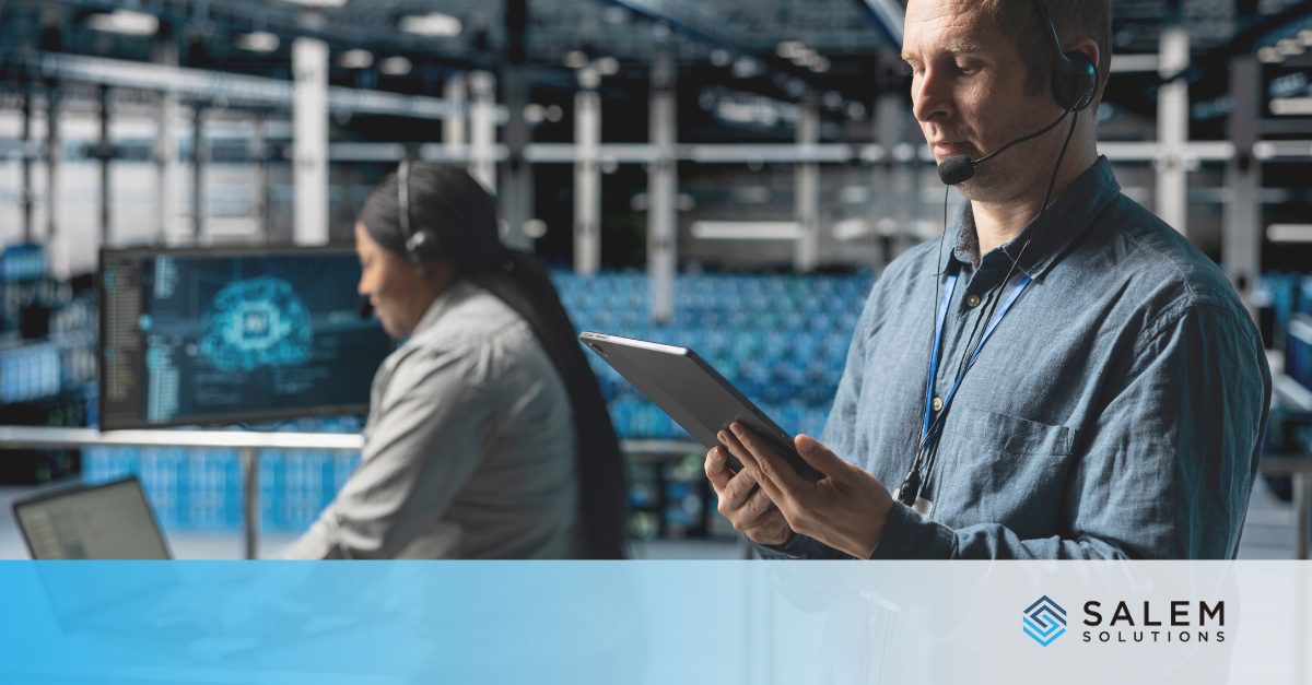 Two technical support staff wearing headsets work in a modern operations center, focusing on call center attrition planning.