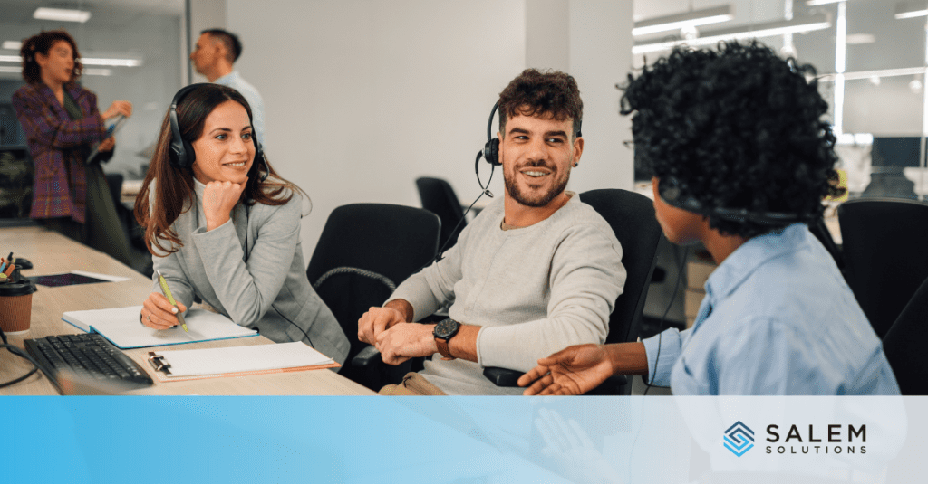 Call center staffing team with headsets meeting to discuss workforce challenges and solutions.