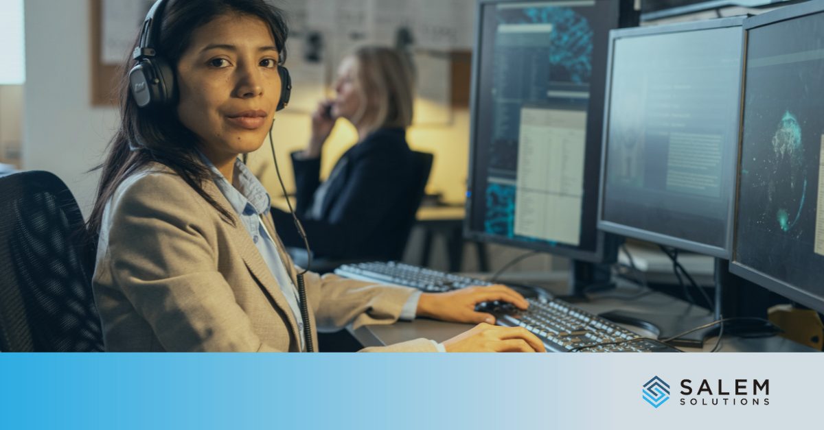 Call center staffing professional with headset managing customer service at multi-screen workstation.