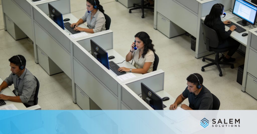 Call center operations during prime contractor staffing ramp-up with customer service representatives at workstations.